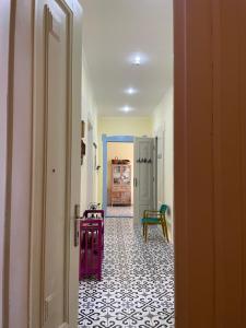 a hallway with a room with a tile floor at Ergzotic Apartments & Room in Sombor