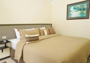 Rúm í herbergi á Yoyita Suites Aruba