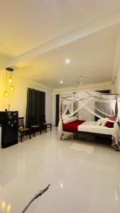 a bedroom with a bed and a living room at Villa J Ambalangoda in Ambalangoda