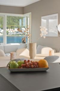 a plate of fruit on a table in a living room at Deluxe Penthouse by Paramount in Tromsø