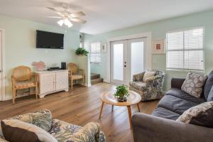a living room with a couch and a table at Sea Esta Suite - Duval Square in Key West