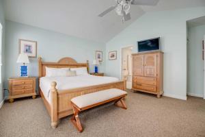 a bedroom with a bed and a dresser and a tv at Sea Esta Suite - Duval Square in Key West