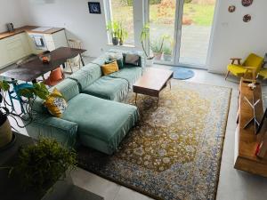 a living room with a green couch and a table at Dom Konin in Konin