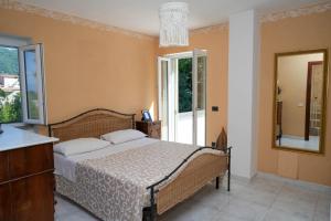 a bedroom with a large bed and a mirror at Casale Conca dei Sogni in Conca della Campania