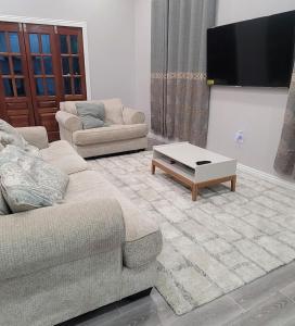 a living room with a couch and a coffee table at The Royal Haven Herstelling GY in Nismes
