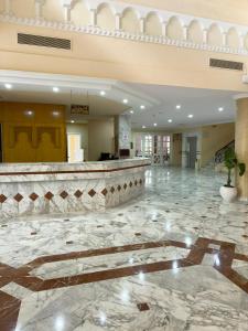 a lobby with a large marble floor and a bar at Green Golf Hammamet in Hammamet +46 photos