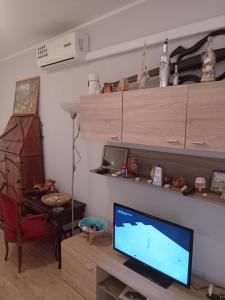 a living room with a desk with a computer and a monitor at Beach 10 in Lido Adriano