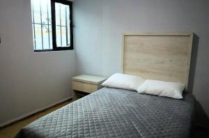 Ένα ή περισσότερα κρεβάτια σε δωμάτιο στο Casa Céntrica