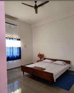 a bedroom with a bed and a ceiling fan at Hotel Ashirwad Palace in Rajaun