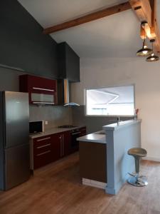 a kitchen with a counter and a stool in it at Julie in Saint-Bonnet-sur-Gironde