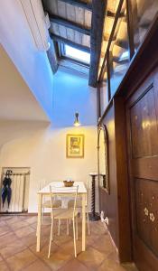 a dining room with a white table and chairs at The Gem - Trastevere Cozy Retreat with pool in Rome