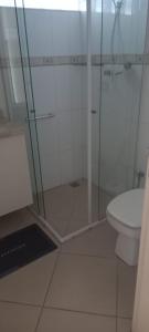 a bathroom with a glass shower and a toilet at santos gonzaga frente pro mar in Santos +5 photos