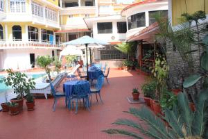 a patio with tables and chairs next to a pool at Hotel Woodland Kathmandu in Kathmandu