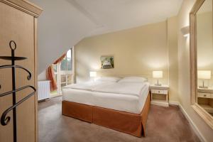a bedroom with a large bed and a staircase at Ferienwohnungen Dünenmeer in Dierhagen +56 photos