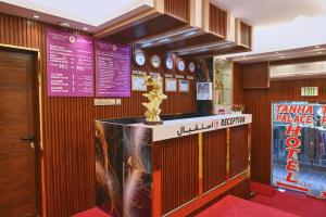 a restaurant with a trophy on top of a counter at Tanha Palace Hotel in Dubai