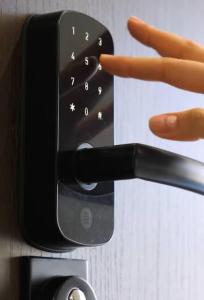 a close up of a hand holding a remote control at Smart House Apartments in Lviv +233 photos