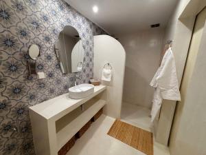 a bathroom with a sink and a mirror at Álas Holiday Home in Archangelos