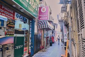 a street with many signs on the sides of buildings at Tanha Palace Hotel in Dubai