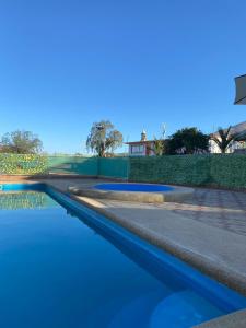 a pool of blue water next to a road at Hostal Panul in Panulcillo +2 photos
