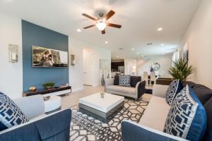 a living room with couches and a ceiling fan at Grand Home Near Disney With Private Pool, Media And Themed Rooms With Waterpark & Resort Access At Encore Resorts Reunion - 360Bu in Orlando