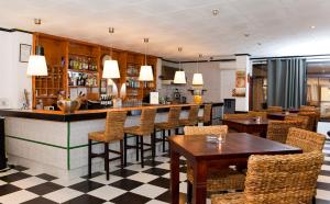 a bar in a restaurant with tables and chairs at Hostal Tierramar in El Arenal