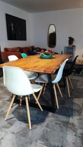 a dining room table with white chairs and a mirror at Villa Dionysos in Plaka