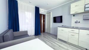 a kitchen with a couch and a tv in a room at A2 autostrada highway close to Warszawa in Słomków