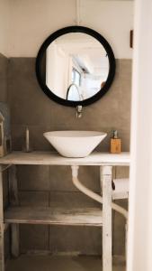 a bathroom with a sink and a mirror at Salty House Cabo Polonio in Cabo Polonio +65 photos
