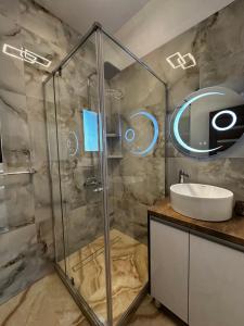 a bathroom with a glass shower and a sink at Cabana Lara in Curtea de Argeş +67 photos
