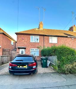 a car parked in front of a house at 4 ensuite Bedroom Entire House Sleeps 10 Driveway Parking near Coventry Univesity and City Center in Coventry