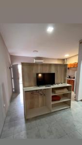 a living room with a tv and a kitchen at Apart La Ideal in Villa Cura Brochero +15 photos