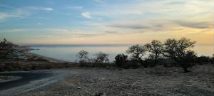 a dirt road with a view of the water at Mountain Taghazout Apartment in Taghazout