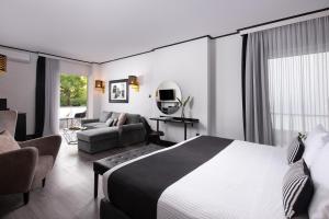 a bedroom with a bed and a living room at Athenian Riviera Hotel& Suites in Athens +37 photos
