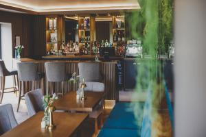a restaurant with a bar with a table and chairs at Everything Retreat in Mellor