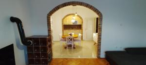 an archway in a living room with a table and a kitchen at Apartment Lovor in Krk