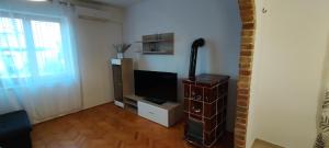 a living room with a flat screen tv in a room at Apartment Lovor in Krk