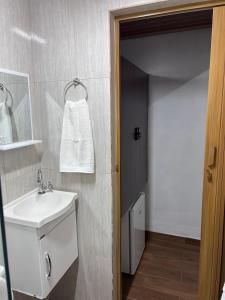 a bathroom with a white sink and a mirror at Pousada Turmalina in Bueno Brandão