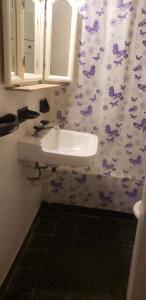 a bathroom with a sink and a mirror at Depto Brown in Mar del Plata +10 photos