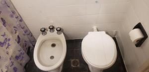 a bathroom with a toilet and a bidet at Depto Brown in Mar del Plata +9 photos
