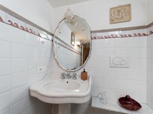 a bathroom with a sink and a mirror at AlCOVA REALE Apartment and organic honey Cisternino cda specchia 33 in Cisternino +35 photos