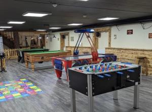 a recreation room with two tables and pool tables at Aspen Lodge in Morpeth