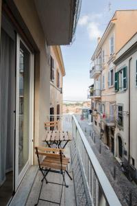 two benches sitting on the balcony of a building at Dimora al belvedere in Frascati