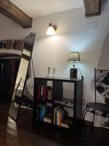 a room with a book shelf with a lamp and a ladder at Antico Pistacchieto GUEST HOUSE in Bronte