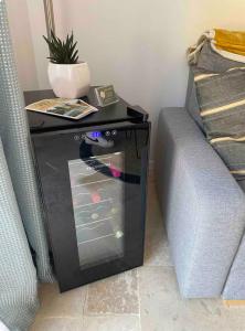 a table next to a couch with a plant on it at La Maison Patricia in Aramon