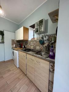 a kitchen with a sink and a dishwasher at Casa Vacanze Il Vicolo - Oliveto Citra in Oliveto Citra