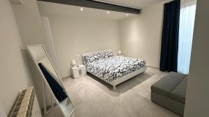 a bedroom with a bed and a television in it at Appartamento Rita in Pisogne