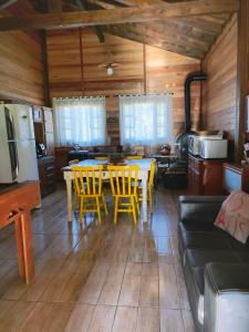 a kitchen and living room with a table and chairs at Sitio Vida in Aguas Mornas +20 photos