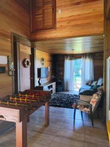 a living room with a ping pong table in it at Sitio Vida in Aguas Mornas