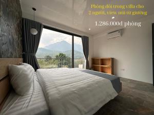 a bedroom with a large bed with a large window at Ba Villa - Nhà của Hạnh Phúc in Ba Vì +14 photos