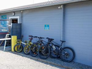 a row of bikes parked next to a garage at Camping Abijune d'Étretat in Le Tilleul +15 photos